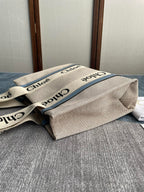 MEDIUM STRAP WOODY TOTE BAG 37 IN BEIGE LINEN CANVAS BLACK WEBBING LOGO EMBROIDER BLUE CALFSKIN
