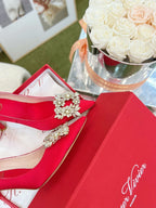 EFFLORESCENCE POINTED-TOE PUMPS IN RED SATIN WITH CRYSTAL BUCKLE
