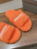 FURRY SLIDES IN ORANGE CURLY SHEARLING