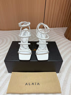 ALAIA THREE-STRAPS HIGH HEEL SANDALS IN WHITE PATENT LAMBSKIN