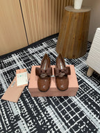 MARY JANE MID HEEL PUMPS IN RUSSET BROWN PATENT LAMBSKIN WITH BOW