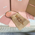 WANDER BUCKET BAG 23 IN NATURAL RAFFIA WITH LEATHER TRIM
