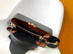 CAPUCINES GM 33CM BLACK GOLD TAURILLON LEATHER 252021