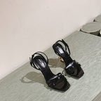 YSL 25S HIGH-HEEL SANDALS 100 MM IN BLACK GLOSSY LAMBSKIN WITH YSL LOGO HEEL DESIGN IN GOLD