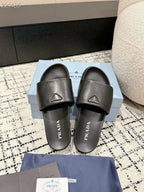 PRADA 25S PADDED SLIDES IN BLACK CALFSKIN WITH LOGO