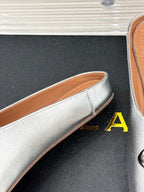 ALAIA FLAT MULE IN SILVER LAMBSKIN WITH SILVER HARDWARE