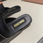 MULES SLIPPERS BLACK COWHIDE WITH GOLD COIN