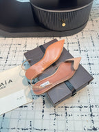 ALAIA FLAT SLINGBACK IN BEIGE BISQUE PATENT CALFSKIN AND FILM