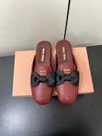 BOW MULES IN RED BROWN SHEEPSKIN