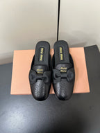 BOW MULES IN BLACK SHEEPSKIN