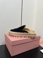 MULES SLIPPERS IN BLACK SUEDE WITH GOLD COIN