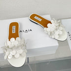 ALAIA FLAT MULE IN WHITE GLOSSY LAMBSKIN