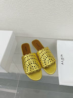 ALAIA VIENNE FLAT MULES IN GOLDEN LAMBSKIN