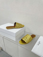 ALAIA VIENNE FLAT MULES IN GOLDEN LAMBSKIN