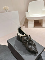 SHORT BOOTS IN BLACK SHEEPSKIN WITH BOW