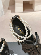 SHORT BOOTS IN BLACK SHEEPSKIN WITH BOW