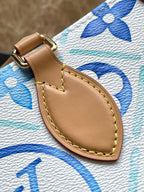 ONTHEGO EAST WEST 25 IN LAGOON BLUE MONOGRAM TILES CANVAS
