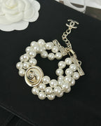 CC ROUND BUTTON RESIN BRACELET WITH THREE LAYERS OF PEARLS