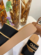 CHLOÉ WOODY WEDGE SANDALS IN BLACK CANVAS WITH CIDER BROWN RUBBER SOLE