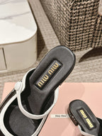 FLAT MULE IN BLACK AND WHITE PATENT CALFSKIN