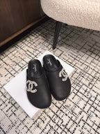 FLAT MULES IN BLACK CALFSKIN