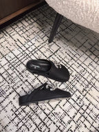 FLAT MULES IN BLACK CALFSKIN