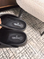 FLAT MULES IN BLACK CALFSKIN