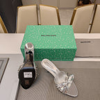 BOW-EMBELLISHED HIGH MULES IN SILVER METALLIC SHEEPSKIN