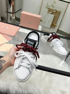 SNEAKER MULES IN BLACK AND WHITE CALFSKIN WHITE RED LACES